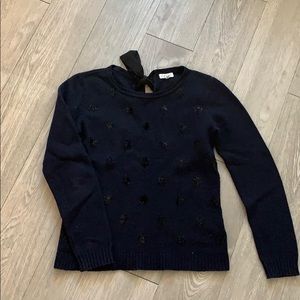 Navy lambswool sweater with a bow on back